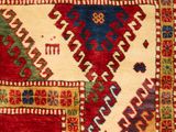 a close up of a rug with a red and blue design