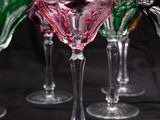 several wine glasses are lined up on a table with a black background