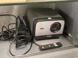 a television and remote control sitting on a shelf