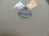 a close up of a plate with a blue and white design