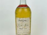 a bottle of liquor sitting on top of a white surface
