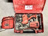 a red tool box with tools in it on the floor