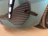 a close up of a blue car with a sticker on the front of it