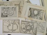 several old maps of a town and a town on a table