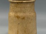 a brown vase that is sitting on a table