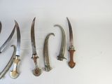 five different types of knives on a white surface