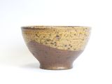 brown and black ceramic bowl on a white background