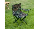 the folding chair is sitting in the grass near a picnic table