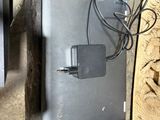 a laptop computer sitting on top of a wooden table