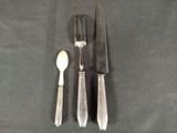 a knife, fork and spoon sitting on a table