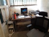 a desk with a computer and a printer on it