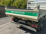 a green and white truck parked in a parking lot