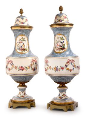 pair of blue and white vases with birds and flowers on them