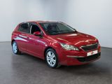 the red car is parked in a white room with a black floor