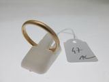 a gold ring with a tag attached to it