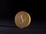 a close up of a gold coin with an image of a woman on it