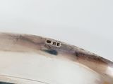 a close up of a silver plate with a number on it