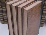 several books stacked on top of each other on a table