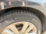 a close up of a tire on the side of a car