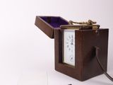 a small wooden box with a clock inside of it