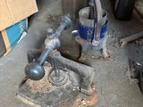 a small machine that is sitting on the floor next to a bucket