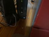 a computer on the floor next to a speaker
