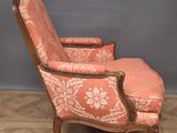 an old chair with a pink upholstered upholstered seat