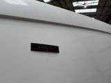 a sticker on the back of a white boat in a warehouse