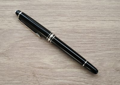 an image of a pen laying on a wooden table