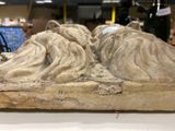 a stone sculpture of a head on top of a table