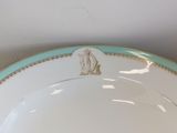a white plate with a gold trim and a blue border