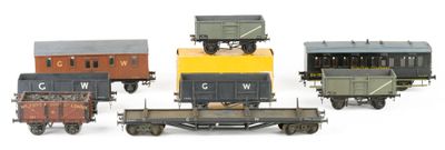 five toy trains that are lined up on a white surface