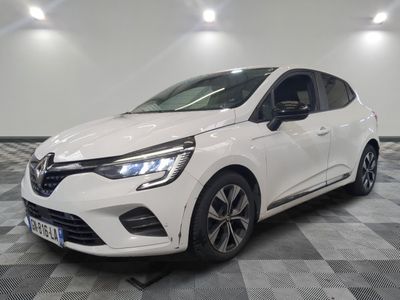a white car is parked on a checkered floor in a garage