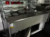 stainless steel counter top in a commercial kitchen with dishes on it