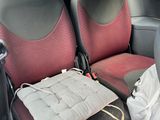 two seats in the back of a car with a bag on the seat