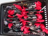 many red plastic spoons in a plastic container