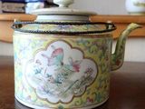 a tea pot sitting on a table with a lid