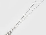an image of a necklace with three diamonds on it