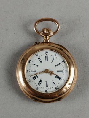 a gold pocket watch with roman numerals on it