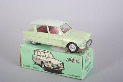 a green toy car sitting on top of a box