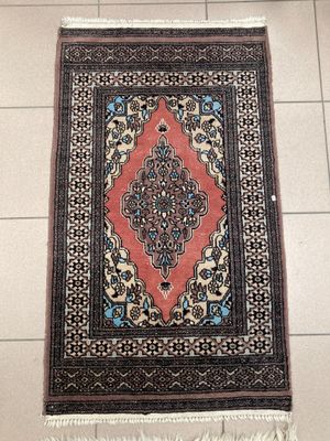 a rug on the floor in a room with tile flooring