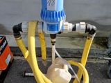 un tuyau jaune raccordé à une borne d'incendie bleue et blanche