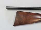 two different types of guns on a white table