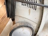 an image of a dirty air conditioner in a garage