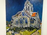une peinture représentant une église accrochée au mur d'une pièce