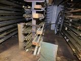a pile of wood in a room with many different types of wood
