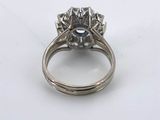 a close up of a diamond ring on a white surface