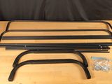 a set of four black steel bars on a wooden table