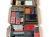 boxes of books are stacked on top of each other on a white surface