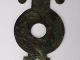 a green stone number eight on a white surface